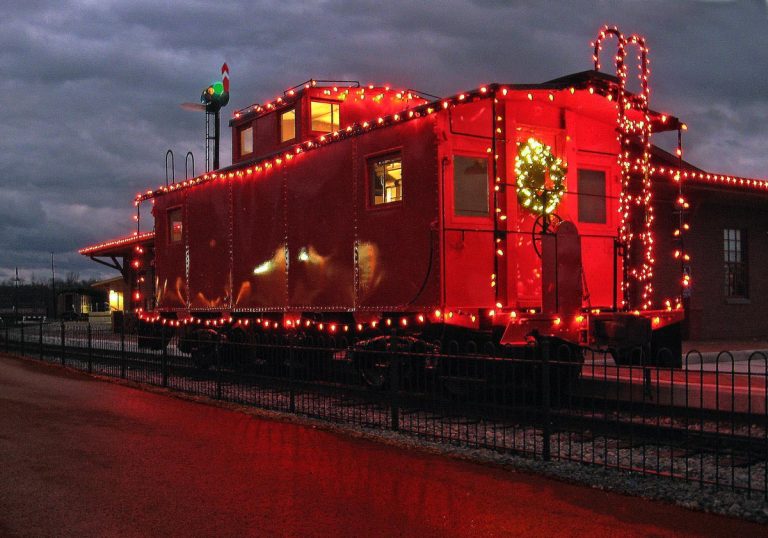 red caboose decorated with christmas lights